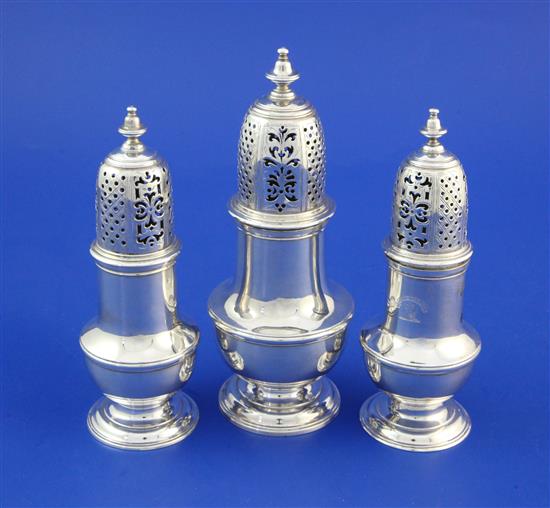 A matched suite of three George II silver casters by Samuel Wood, largest 6.75in.